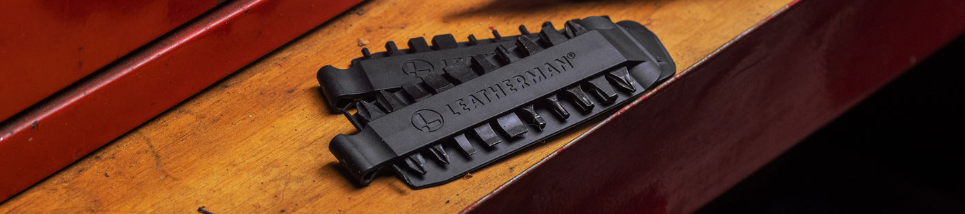 Translation missing: en.Close-up of a Leatherman Bit Kit set on a wooden surface, showcasing the detailed design and functionality
