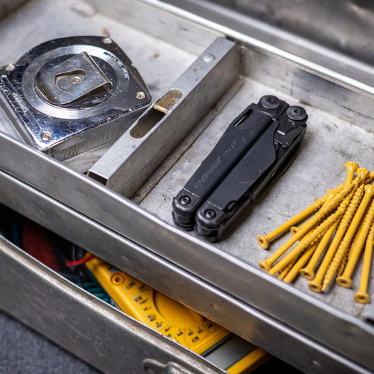 Translation missing: en.Closed Surge laying on a metal tray next to a tape measure and nails
