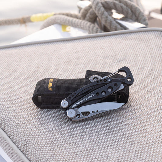Translation missing: en.Leatherman Skeletool CX and a black nylon sheath on a boat chair