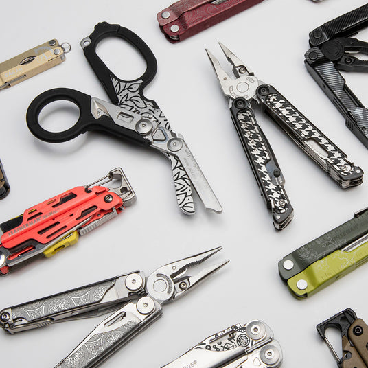 Translation missing: en.An assortment of Leatherman multi-tools arranged on a table, highlighting their diverse shapes and features
