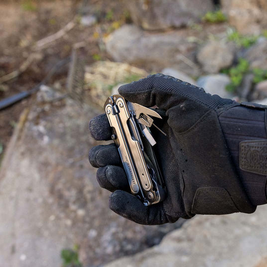 Translation missing: en.A gloved hand holding an ARC with some included tools showing