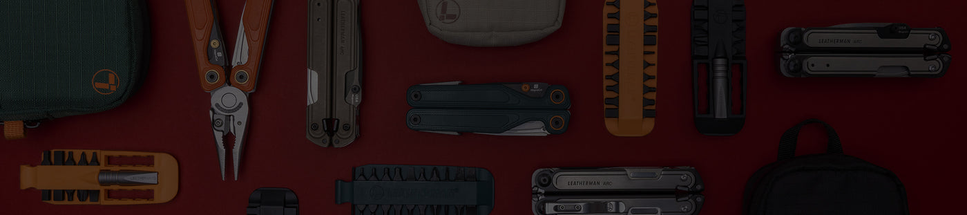 Translation missing: en.A variety of Leatherman tools in different styles are arranged on a vibrant red surface