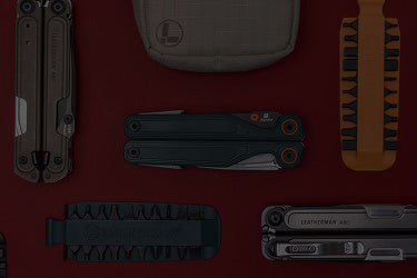 Translation missing: en.A variety of Leatherman tools in different styles are arranged on a vibrant red surface
