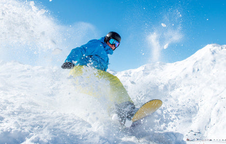 man absolutely shredding on a snowboard