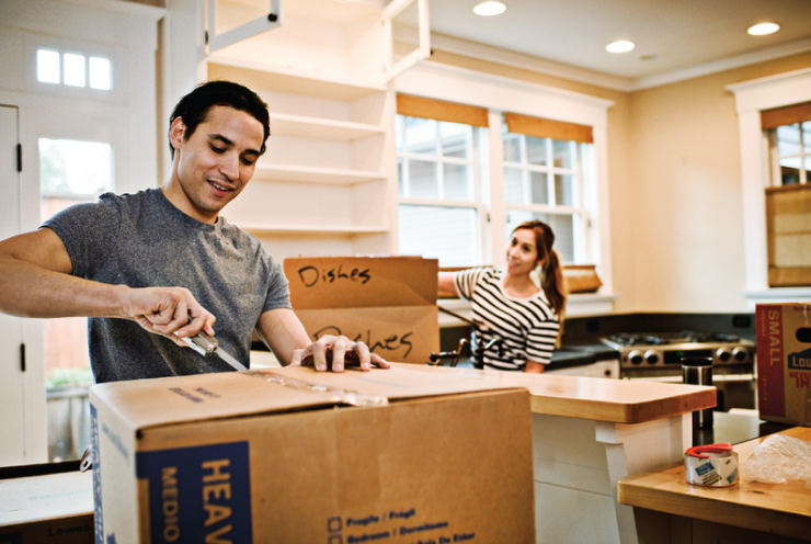 Man opening a box with a Leatherman.