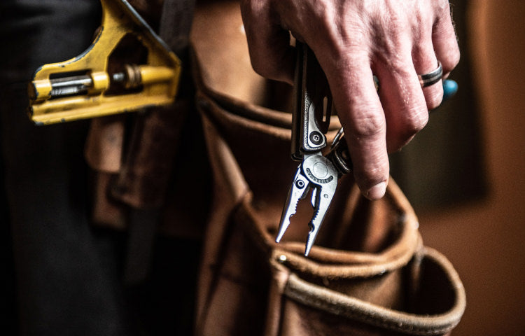 Hand holding charge TTi with pliers deployed