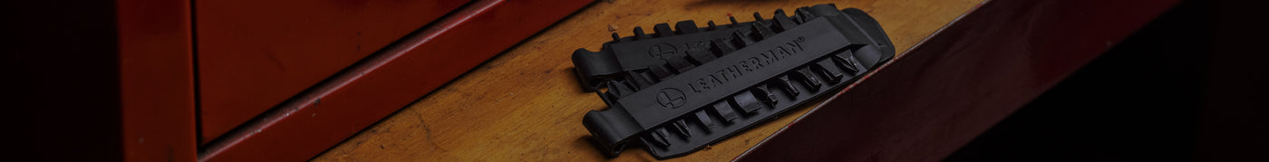 Translation missing: en.Close-up of a Leatherman Bit Kit set on a wooden surface, showcasing the detailed design and functionality
