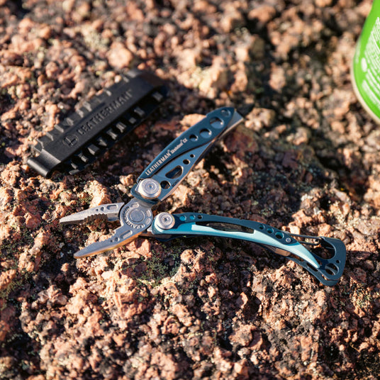 Skeletool CX next to Bit Kit paddle on the ground