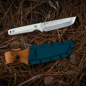 Translation missing: en.Leatherman Alpine Pioneer knife displayed alongside its leather sheath, showcasing the blade and protective cover in a neutral setting