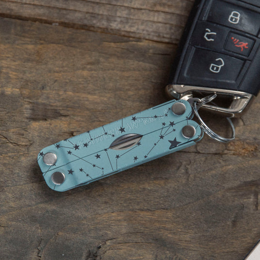 Custom Arctic Micra attached to a car key laying on a table.