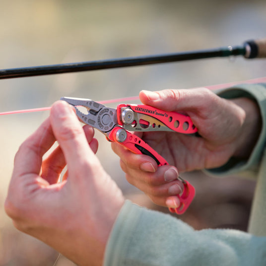 Person using Guava Skeletool CX pliers to fix a fishing line.