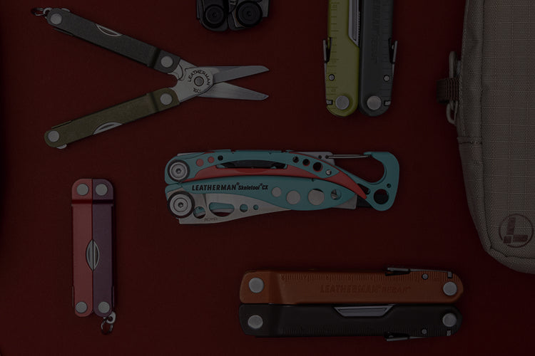 Translation missing: en.A variety of Leatherman tools in different styles are arranged on a vibrant red surface