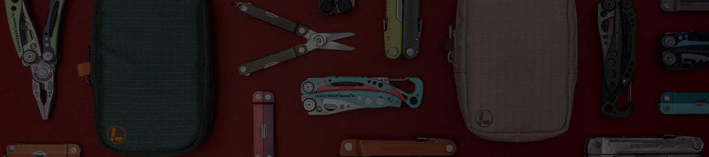 Translation missing: en.A variety of Leatherman tools in different styles are arranged on a vibrant red surface