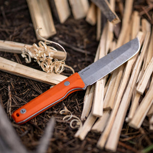 Translation missing: en.A Leatherman Orange pop Pioneer knife resting on a wooden surface, showcasing its blade and handle against the natural texture of the wood