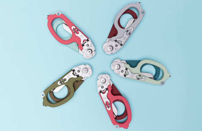 Translation missing: en.Five colorful Leatherman Raptor Rescue multi-tools arranged on a light blue background