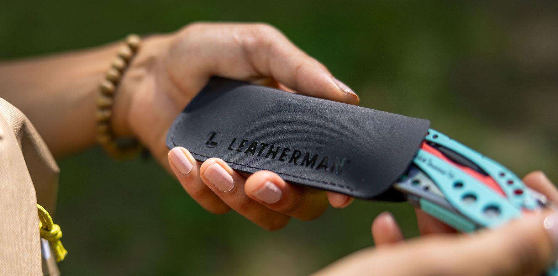 Hypalon Tool Sleeve with a paradise Skeletool CX being removed from a snug fit