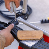 Translation missing: en.Leather brown tool sleeve set to the side as someone uses the Phillips screwdriver on a Super Tool® 300 to put together some framing